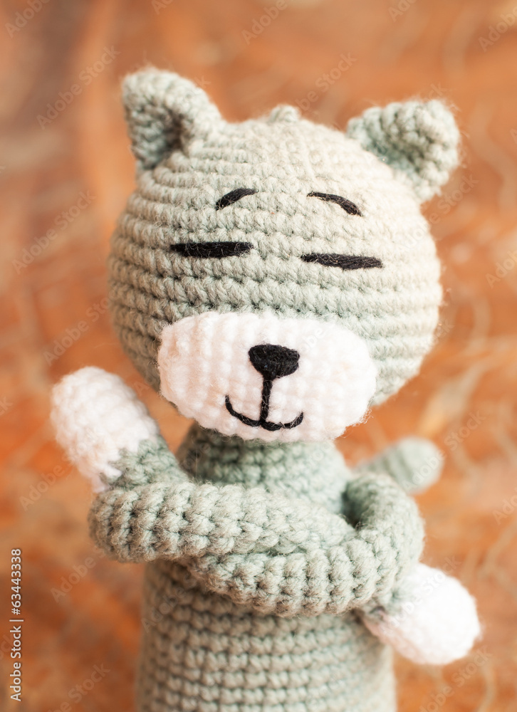 Knitted toy tabby cat isolated on white background Knitted toy tabby cat isolated on white background