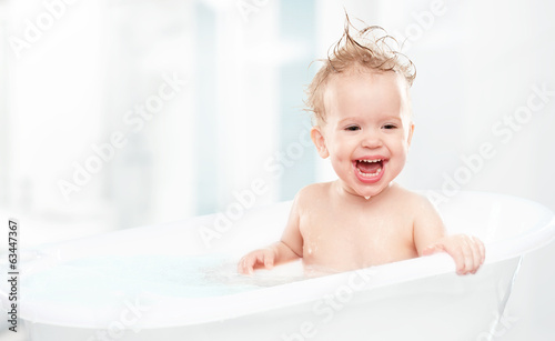 happy funny  baby  laughing and bathed in bath