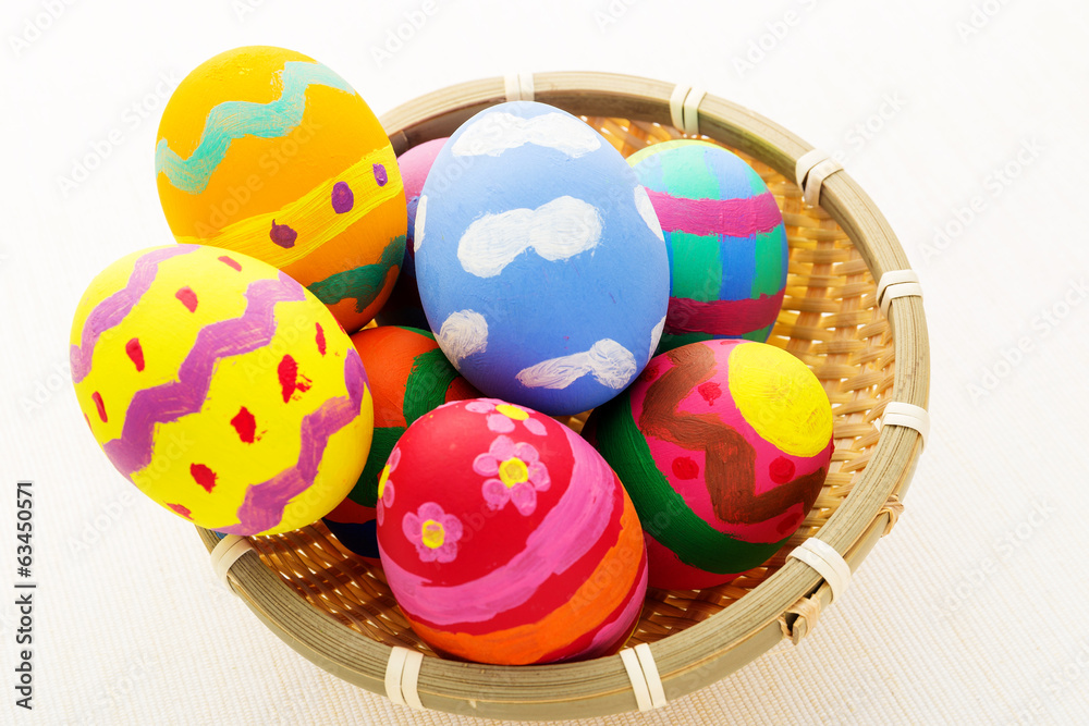 Colourful easter egg in wicker basket