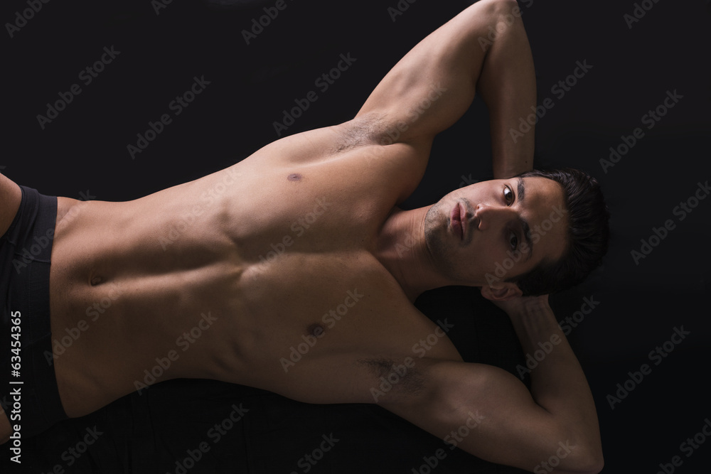Handsome latin young man naked on floor