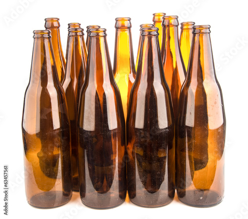 Brown beer bottles stacked isolated on white background