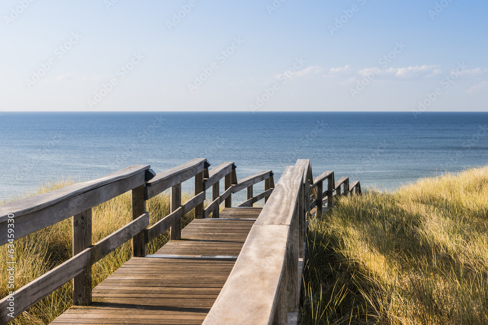Wooden footpath through dunes at the North sea beach in Germany. Wooden footpath through dunes at the North sea beach in Germany.