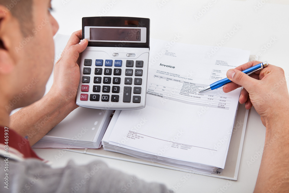 Man Calculating Financial Expenses At Home Man Calculating Financial Expenses At Home