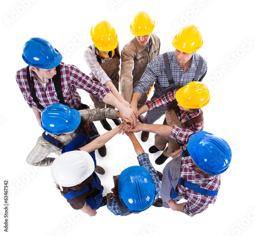 Construction worker stacking hands