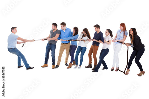 Group of people having a tug of war photo
