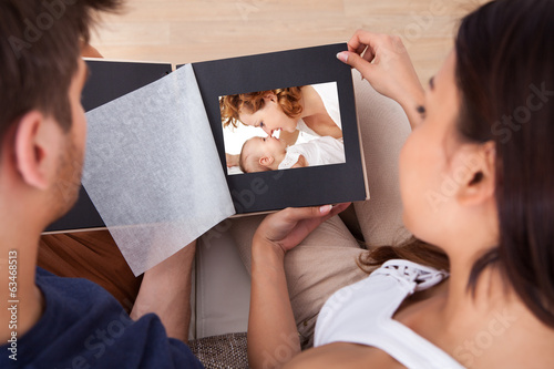 Couple Looking Through Photo Album