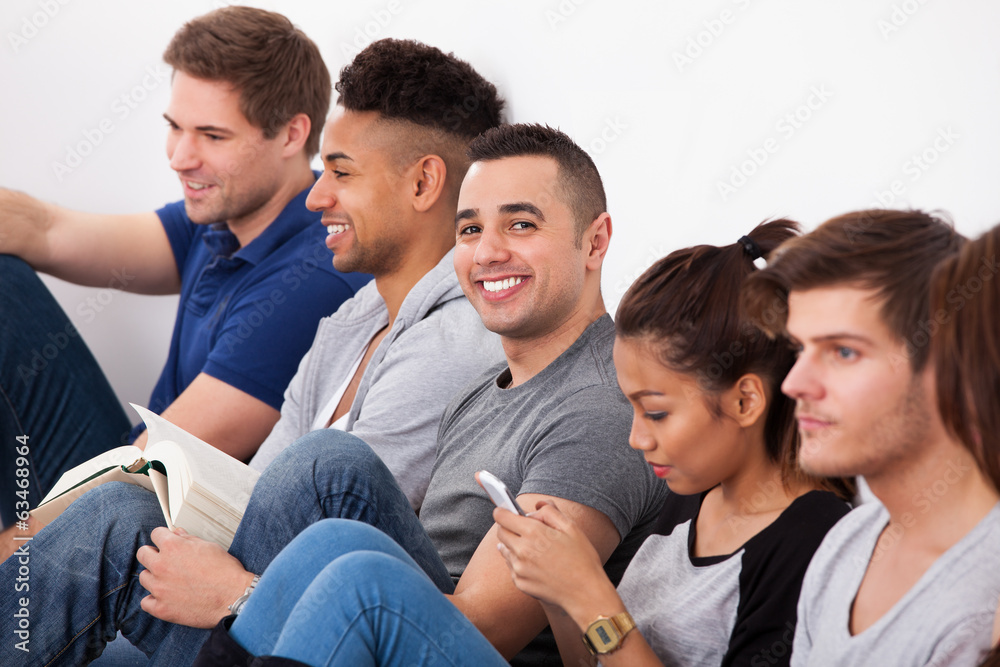 Happy College Student Sitting With Classmates Happy College Student Sitting With Classmates