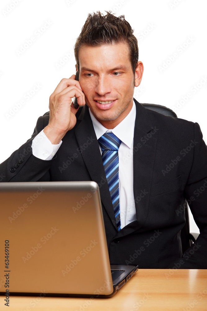 Handsome businessman in suit talks into the mobile phone Handsome businessman in suit talks into the mobile phone