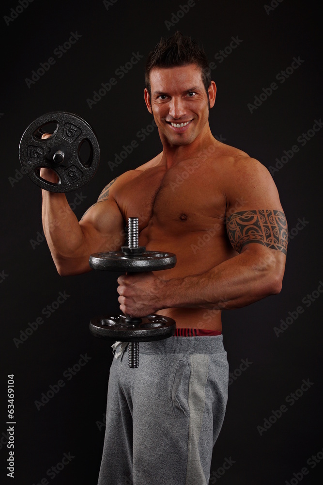 Muscular man holding dumbbell exercises and biceps muscle