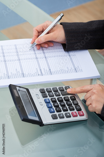 Businesswoman Calculating Tax