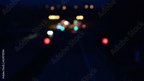 Defocused night car lights at highway tunnel