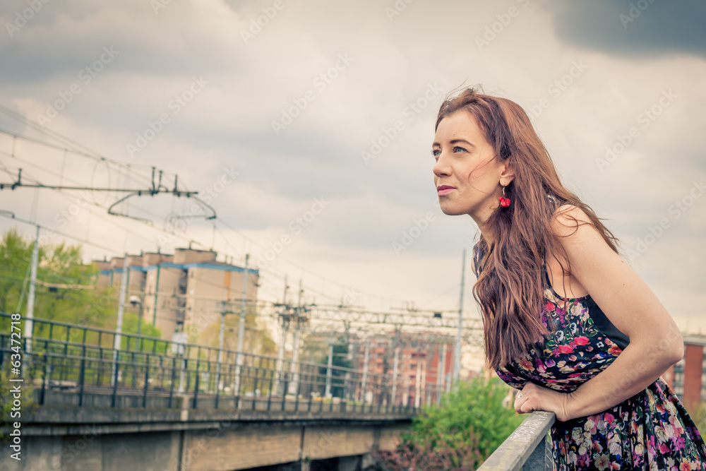 Pretty girl posing on railroad bridge