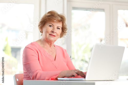 Close-up of a senior woman with laptop