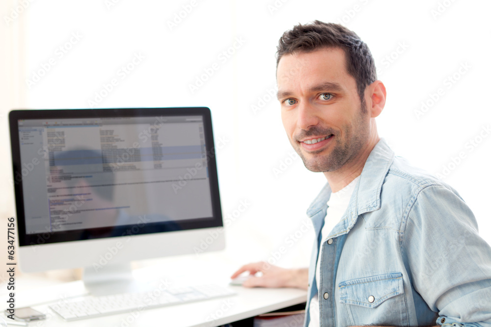 Portrait of a young relaxed man using computer Portrait of a young relaxed man using computer