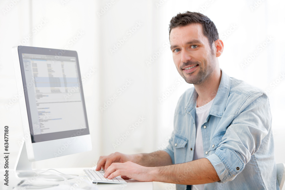 Portrait of a young relaxed man using computer