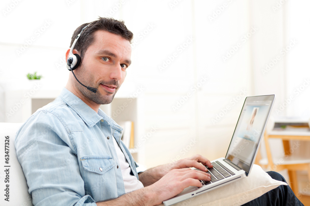 Young relaxed man video-calling on Internet Young relaxed man video-calling on Internet