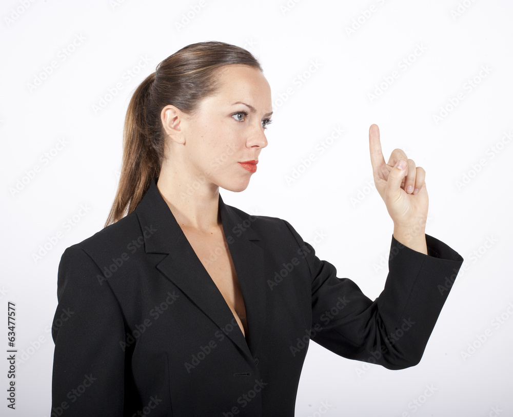blonde Frau im Anzug hebt den Zeigefinger blonde Frau im Anzug hebt den Zeigefinger
