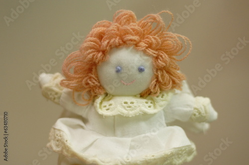 Knitted doll in a white dress