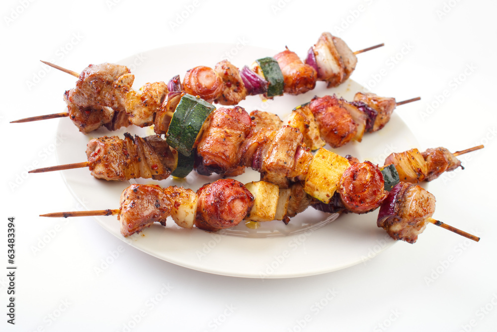 Grilled skewers with meat and vegetables on dish