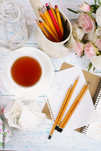 Composition with notebook and pencils on wooden table close-up photo