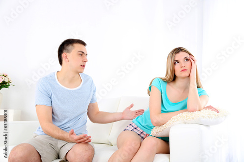 Young man and woman  conflict sitting