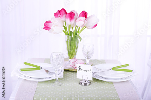 New table with place settings on light background