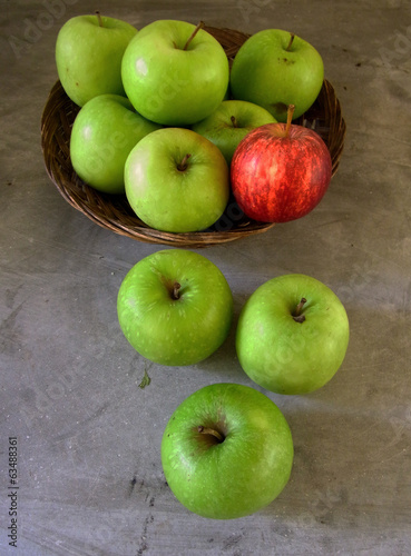 green apples and a red apple