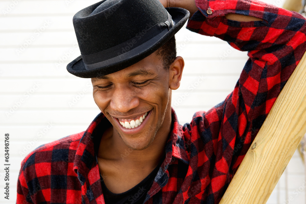 Young black man laughing outdoors Young black man laughing outdoors