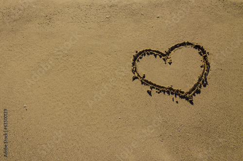 Heart drawn on sand on the beach