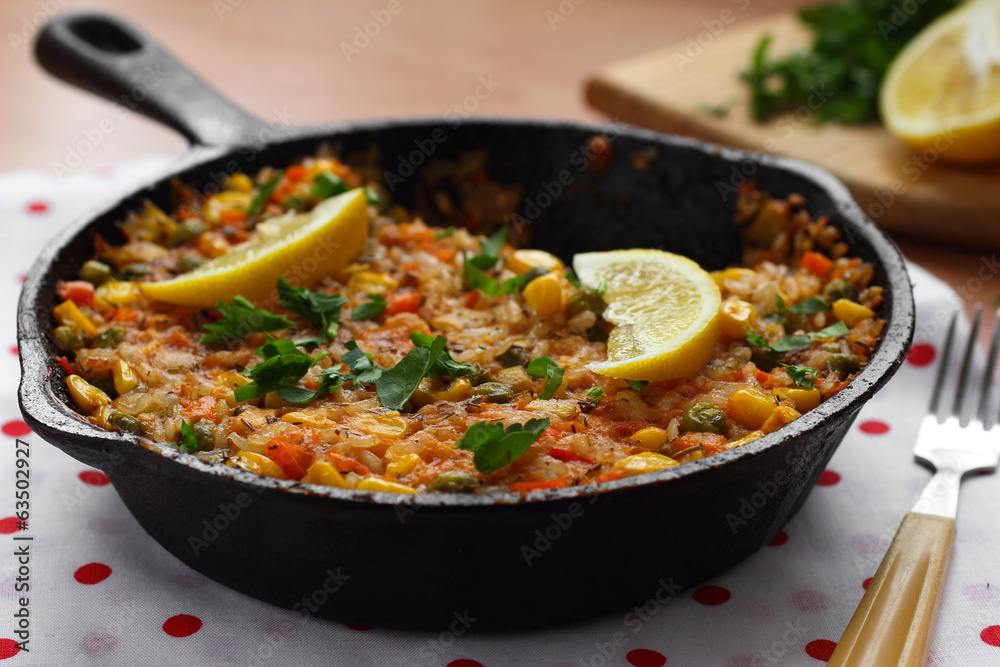 Vegetable paella with corn and green peas