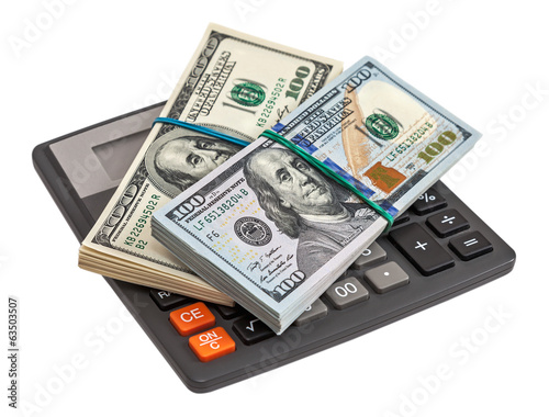 Calculator and dollars on the white background