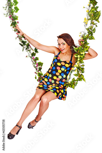 Beautiful girl swinging on flower swing.