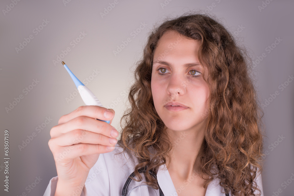 Fototapeta premium Medical female doctor with thermometer