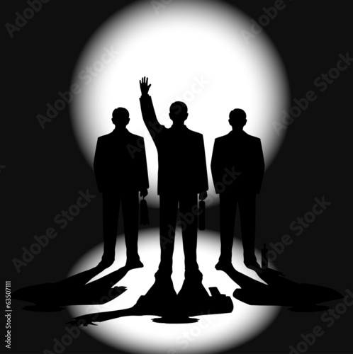 silhouettes of businessmen against a ray of light