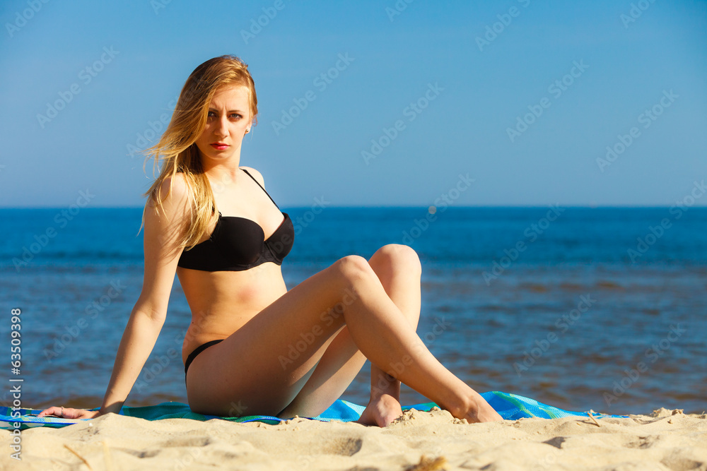 Summer vacation Girl in bikini sunbathing on beach Summer vacation Girl in bikini sunbathing on beach