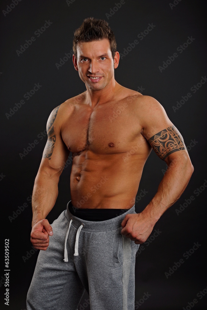 Handsome muscular man standing poses Handsome muscular man standing poses