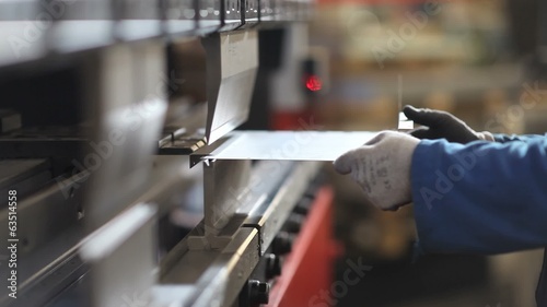 hands that bend sheet metal worker in the factory