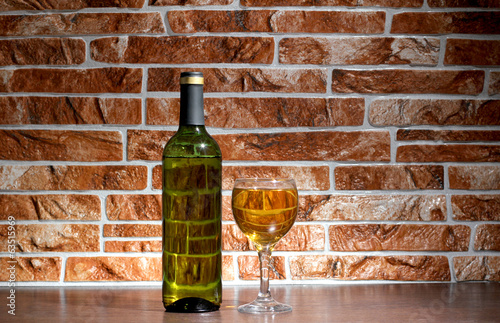 Wine of bottle on brick photo