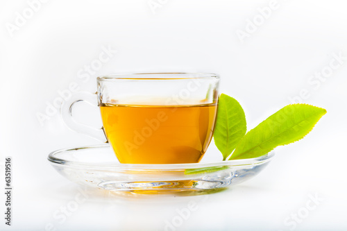 Green tea leaf and glass cup of black tea isolated on white back