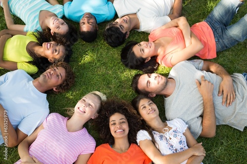 Multiethnic friends lying down in park