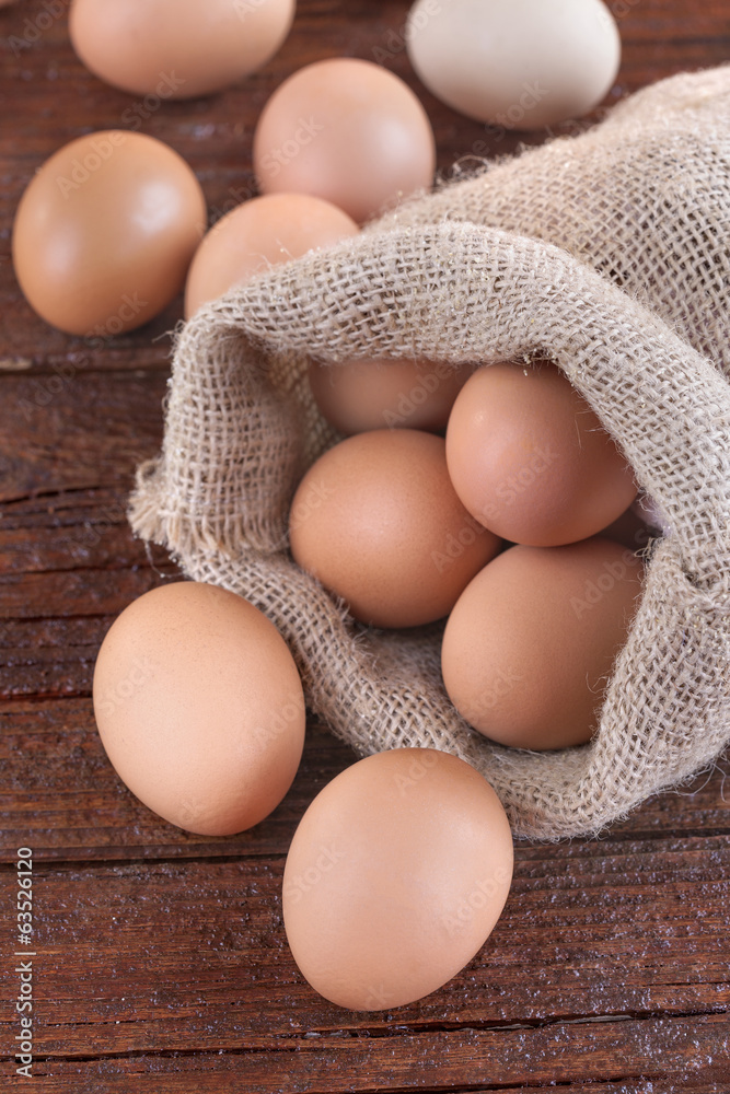 eggs in a linen sack on the wooden table eggs in a linen sack on the wooden table