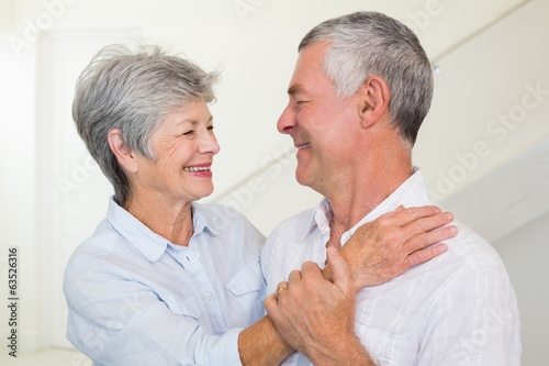 Affectionate retired couple smiling at each other