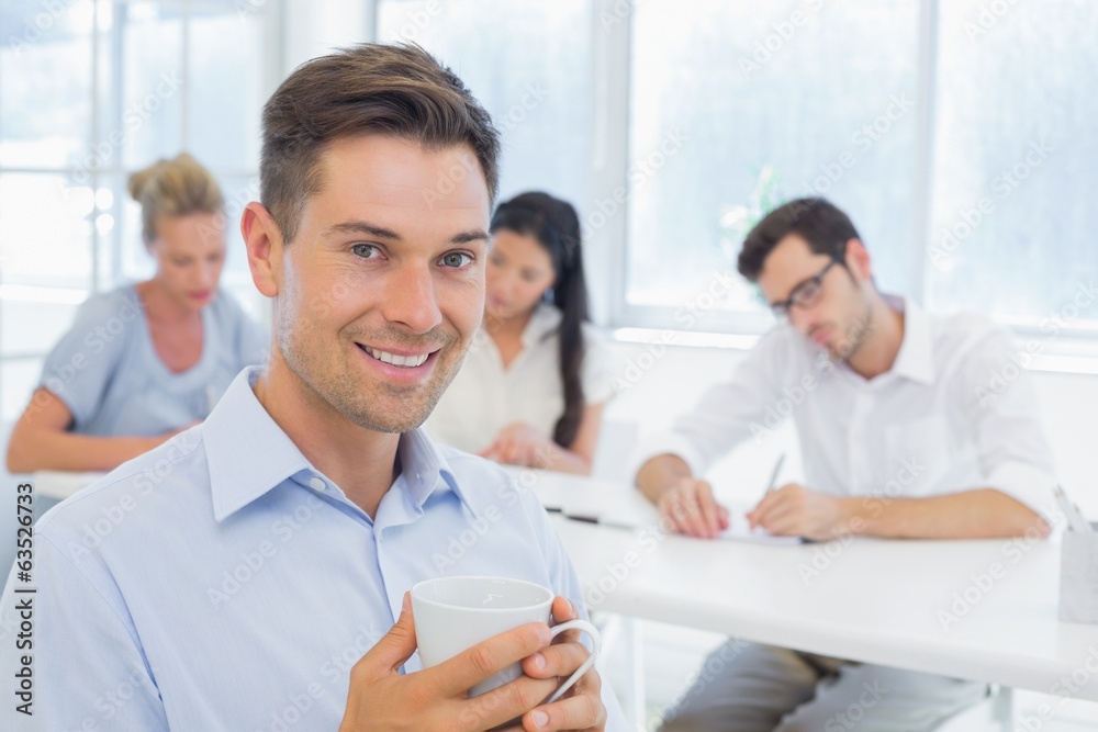 Casual businessman smiling at camera during meeting Casual businessman smiling at camera during meeting