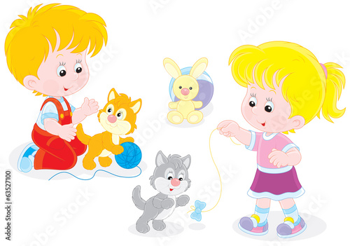 Little girl and boy playing with small playful kittens