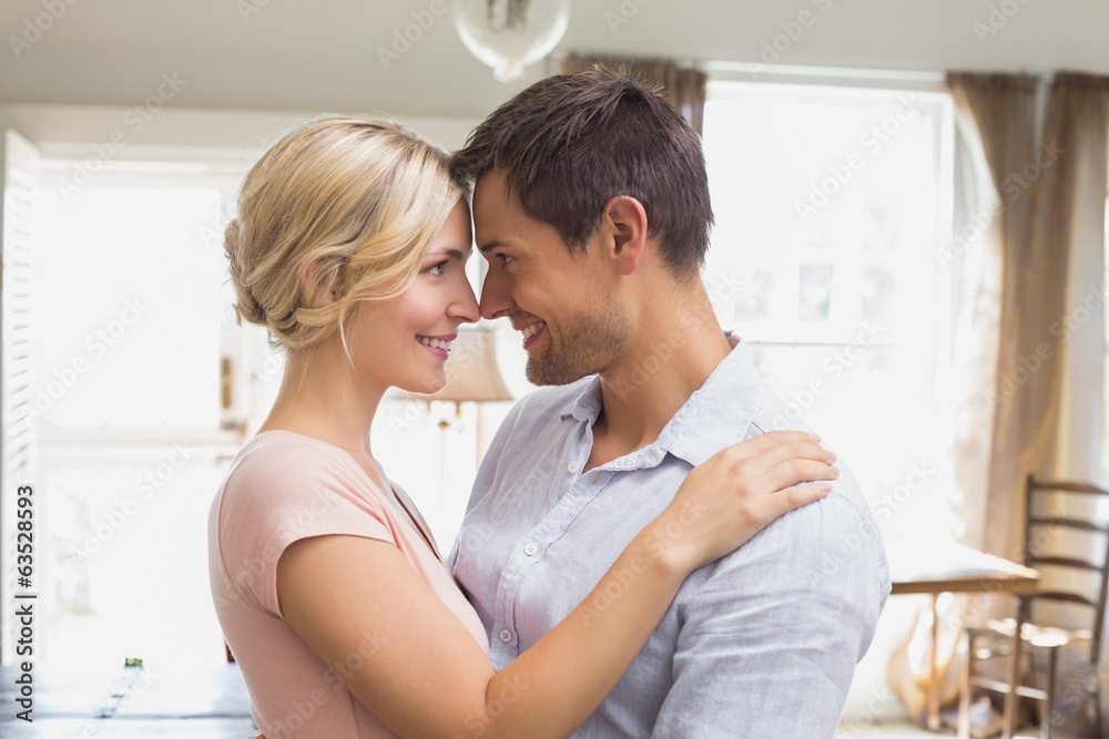 Loving couple looking at each other at home