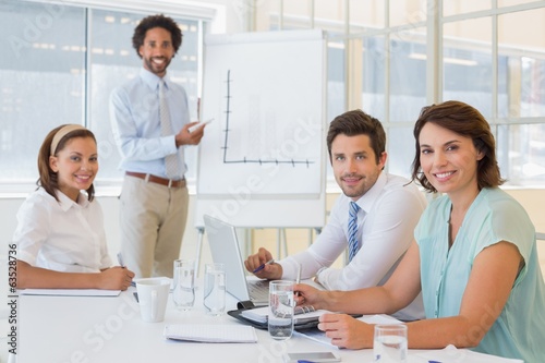 Businessman giving presentation to colleagues in office