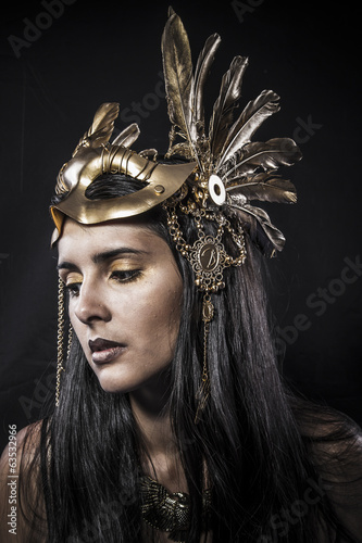 Cosmetic, ensual young woman with golden mask jewelry photo