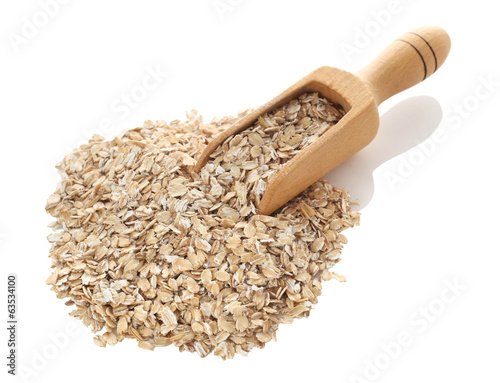 Oat flakes in wooden scoop