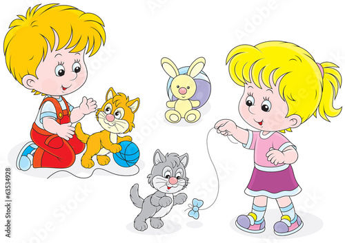 Little girl and boy playing with small playful kittens