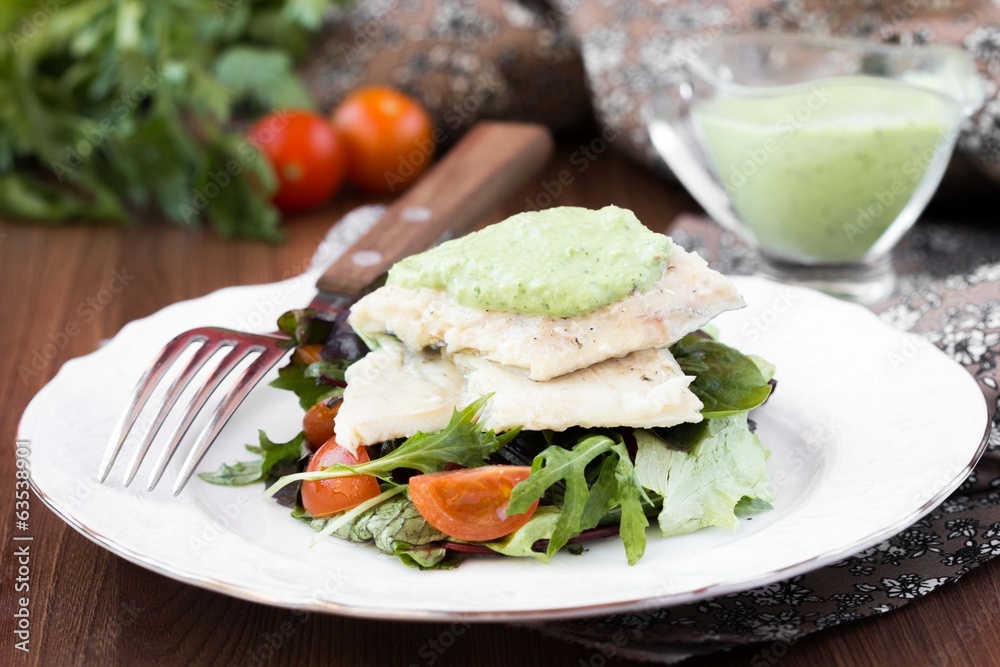Fried white fish fillet with salad of tomatoes, arugula, herbs Fried white fish fillet with salad of tomatoes, arugula, herbs